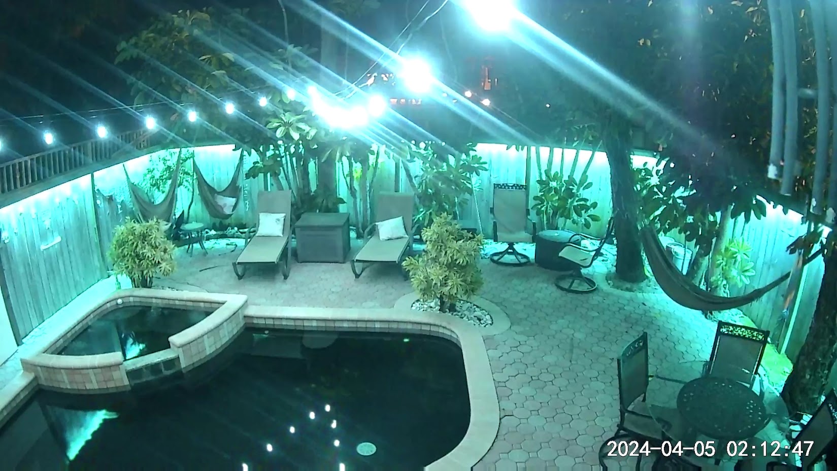 Nighttime smart home camera coverage overlooking a Cocoa Beach patio and pool area